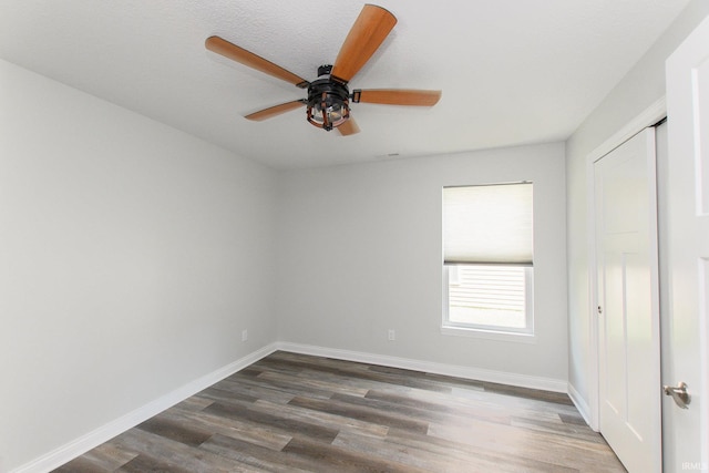 unfurnished room featuring ceiling fan and dark hardwood / wood-style floors