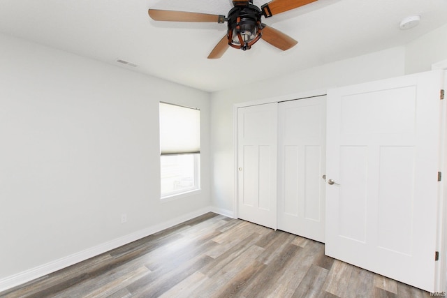 unfurnished bedroom with a closet, ceiling fan, and light hardwood / wood-style flooring