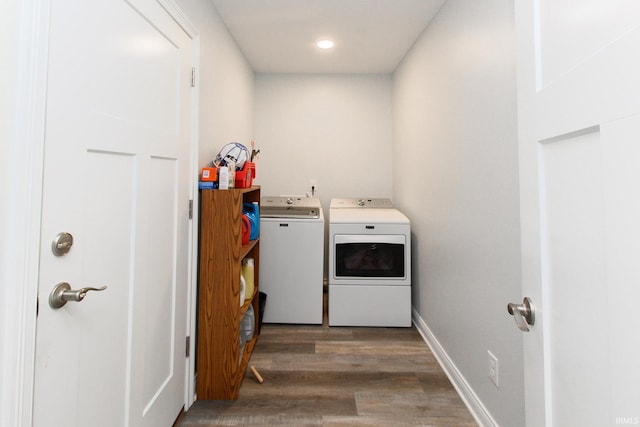 laundry area with washing machine and clothes dryer and dark hardwood / wood-style floors