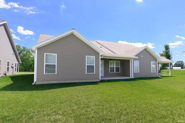 rear view of house featuring a lawn