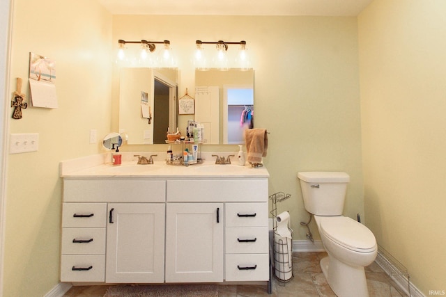 bathroom featuring tile patterned flooring, vanity, and toilet