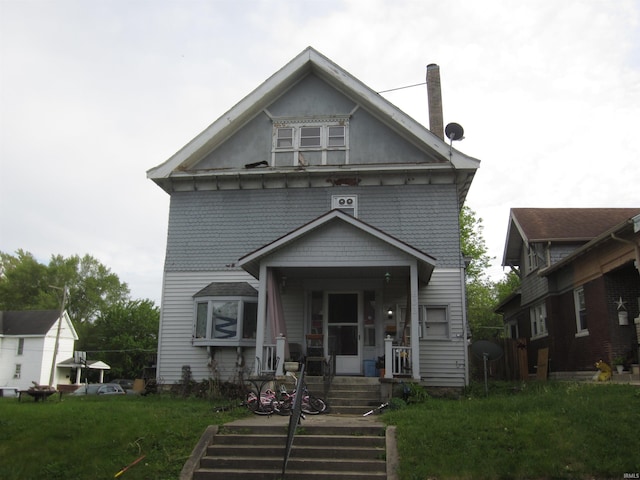 view of front of home featuring covered porch and a front yard