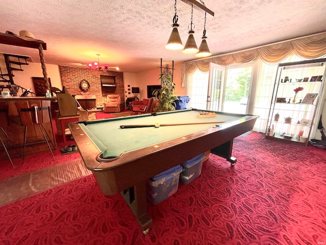 recreation room featuring billiards, dark colored carpet, and a fireplace