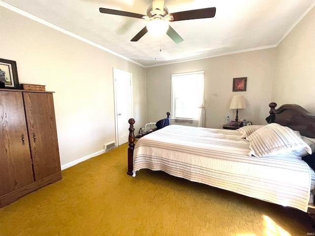 carpeted bedroom featuring ceiling fan and crown molding