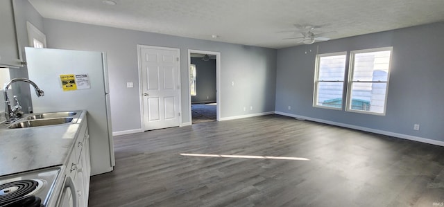 kitchen featuring dark hardwood / wood-style floors, sink, white cabinets, range, and ceiling fan