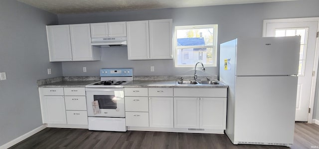 kitchen with sink, white appliances, dark wood-type flooring, plenty of natural light, and white cabinets