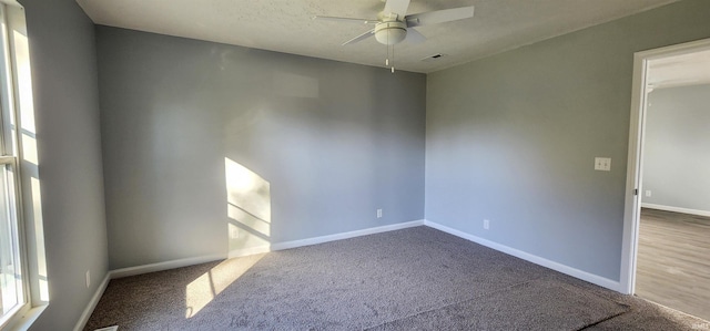 carpeted spare room with ceiling fan