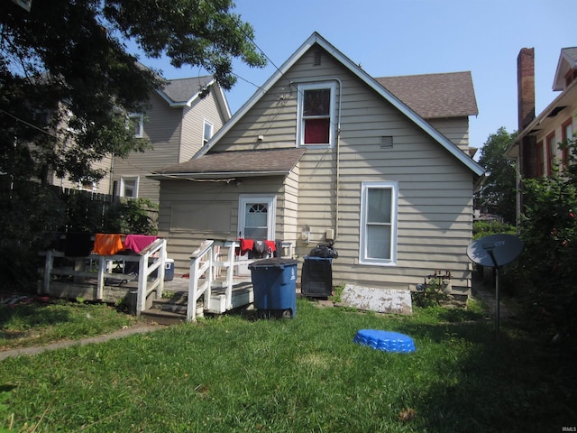 back of property featuring a lawn