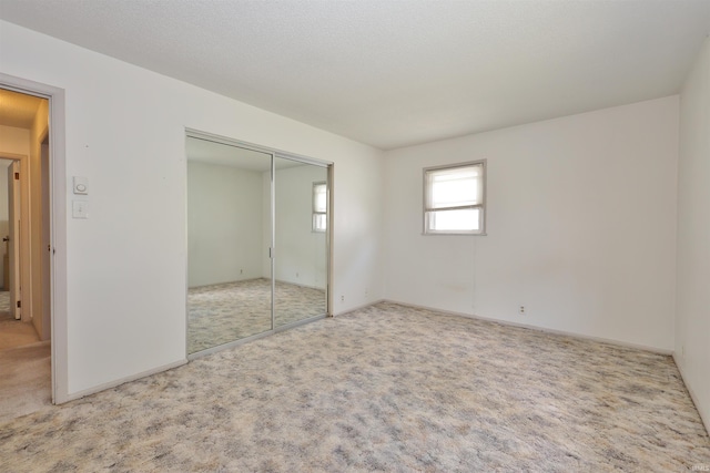 unfurnished bedroom with carpet and a closet