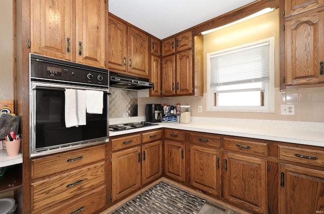 kitchen featuring tasteful backsplash, oven, and white gas stovetop