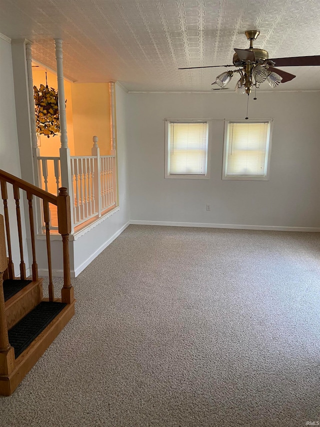 empty room featuring a textured ceiling, carpet floors, and ceiling fan