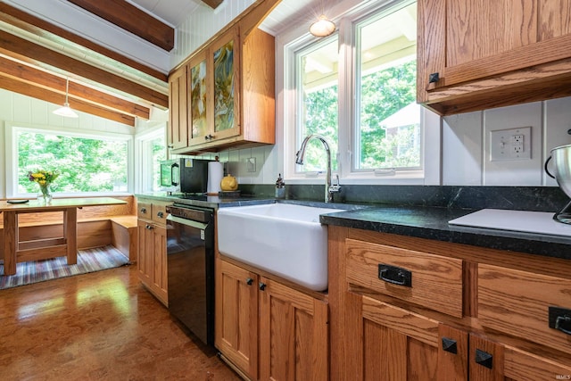 kitchen featuring a healthy amount of sunlight, sink, pendant lighting, lofted ceiling with beams, and black dishwasher