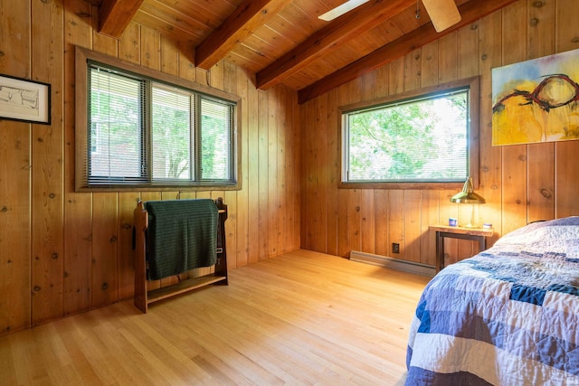 bedroom with vaulted ceiling with beams, wood ceiling, multiple windows, and a baseboard heating unit