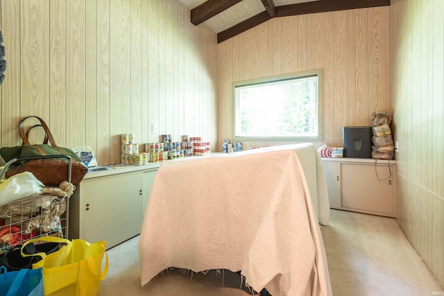 bedroom featuring vaulted ceiling with beams, wood walls, wood ceiling, and light carpet