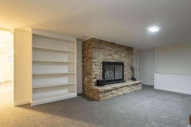 unfurnished living room with a fireplace, carpet, and built in features