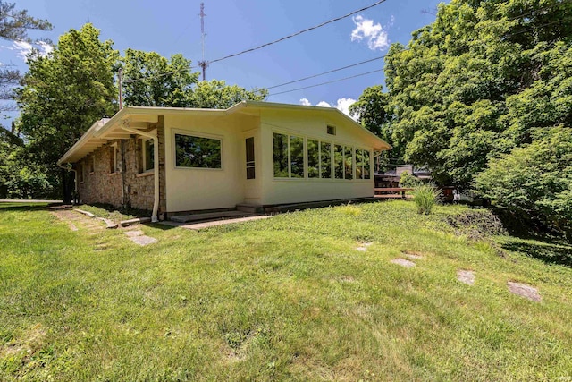 back of house featuring a yard