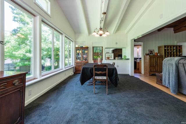 interior space featuring lofted ceiling with beams, an inviting chandelier, and plenty of natural light