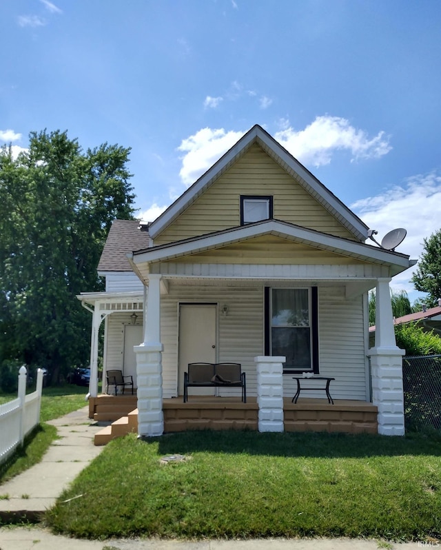 bungalow-style house with a front yard and a porch