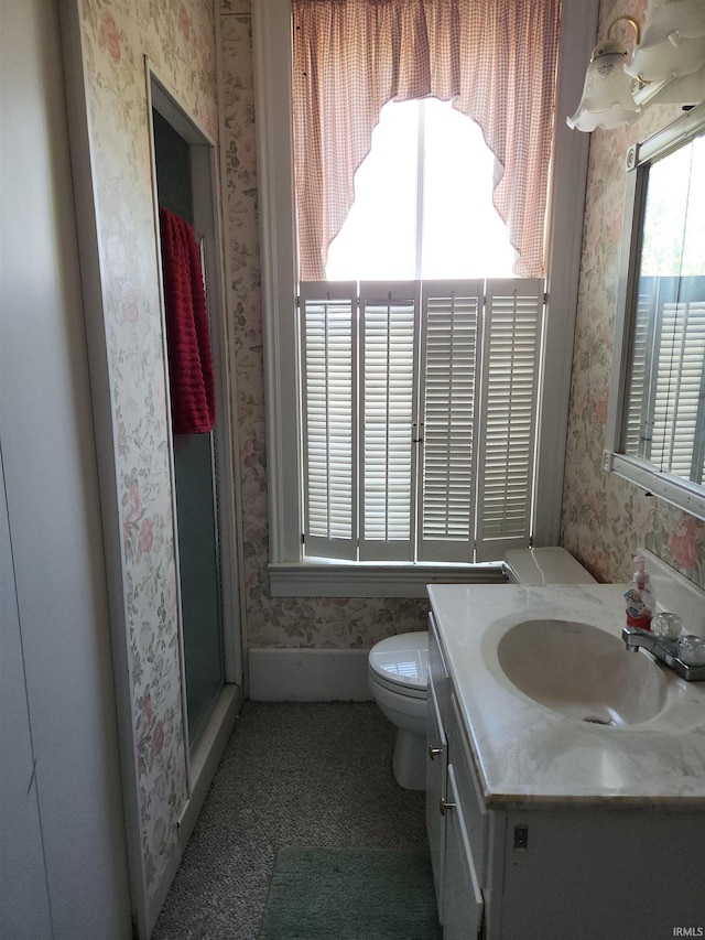 full bath featuring vanity, toilet, and wallpapered walls