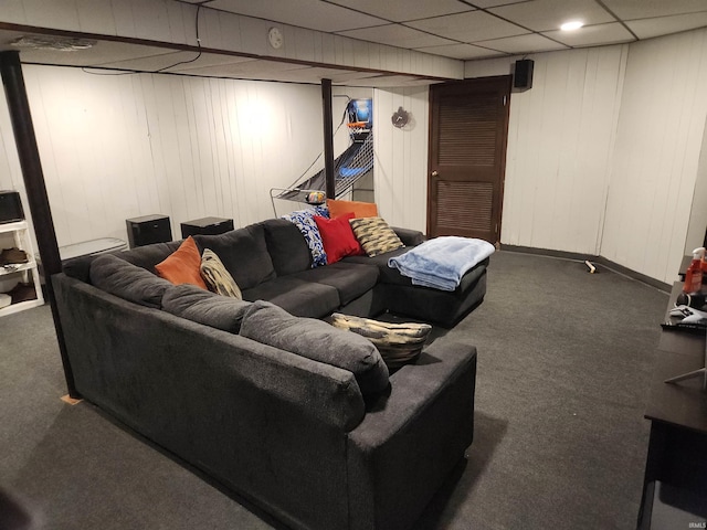 carpeted living area featuring a paneled ceiling