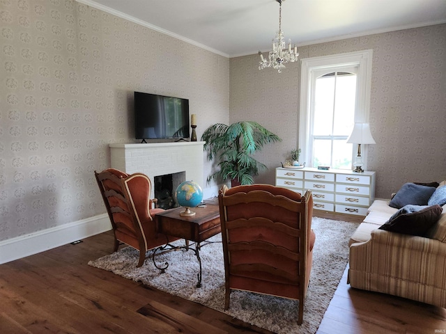 interior space with wood finished floors, baseboards, a brick fireplace, wallpapered walls, and crown molding