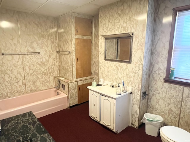 bathroom with a paneled ceiling, sink, and toilet