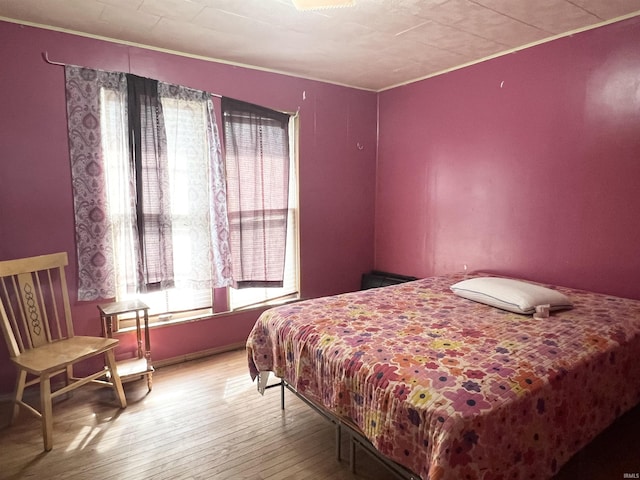 bedroom with hardwood / wood-style floors