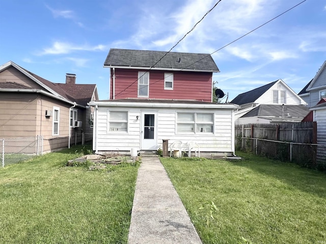 rear view of house featuring a lawn