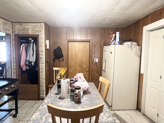 dining room featuring wooden walls