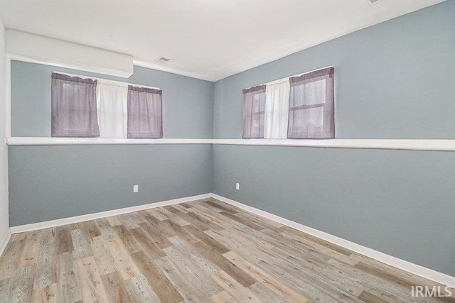 spare room with light hardwood / wood-style flooring