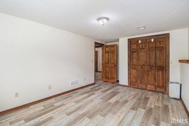 unfurnished bedroom featuring light wood-type flooring