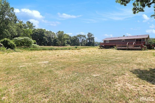 view of yard featuring a rural view and a deck