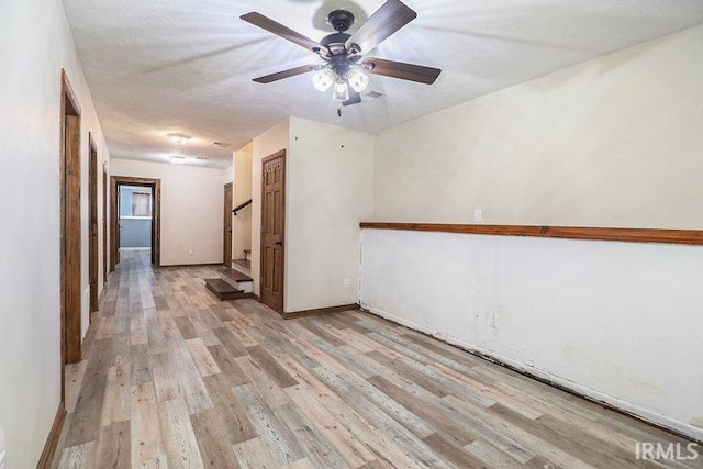 unfurnished room featuring ceiling fan and light hardwood / wood-style flooring