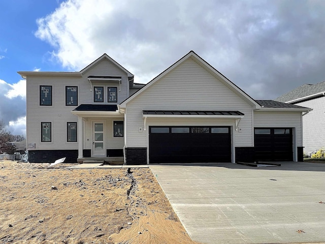 view of front of property with covered porch and a garage