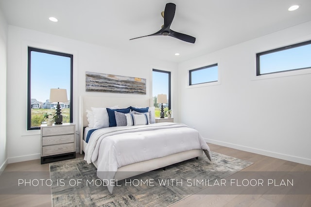 bedroom with ceiling fan and hardwood / wood-style floors