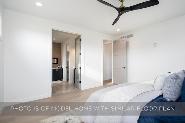 bedroom featuring connected bathroom, hardwood / wood-style flooring, and ceiling fan