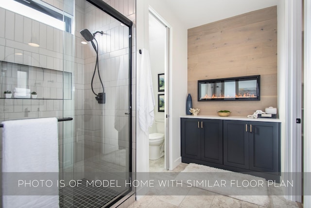 bathroom with toilet and an enclosed shower