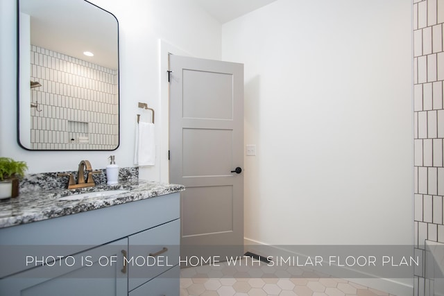 bathroom featuring vanity, tile patterned floors, and walk in shower