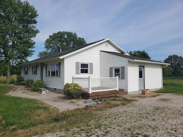 rear view of property with a wooden deck