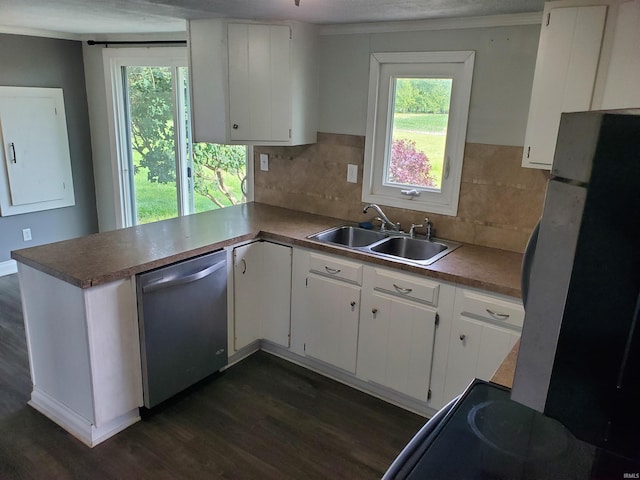 kitchen featuring tasteful backsplash, stainless steel dishwasher, dark wood-type flooring, sink, and white cabinetry