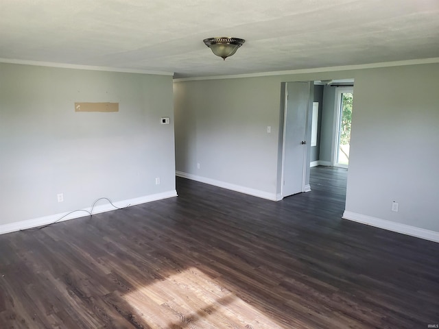 spare room with dark hardwood / wood-style flooring and crown molding