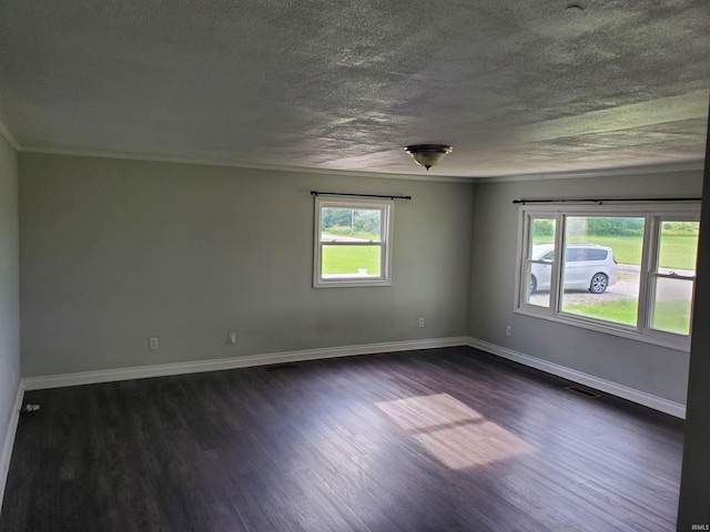 unfurnished room with a textured ceiling, crown molding, and dark wood-type flooring