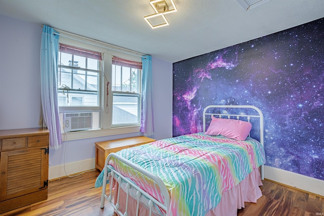 bedroom featuring cooling unit and wood-type flooring