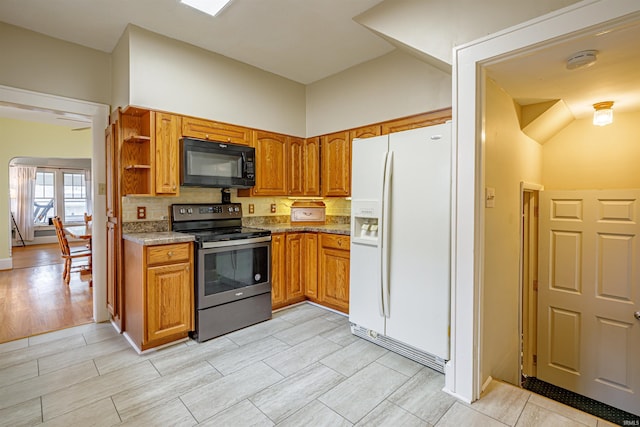 kitchen with stainless steel electric stove, decorative backsplash, light hardwood / wood-style floors, and white refrigerator with ice dispenser