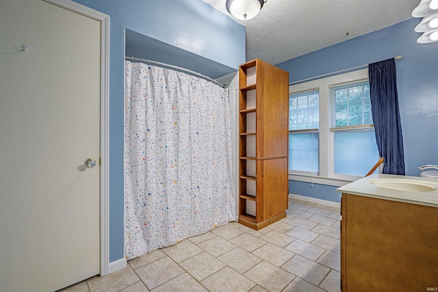 bathroom with vanity, a shower with curtain, and a textured ceiling