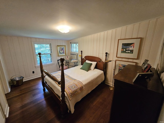 bedroom with dark hardwood / wood-style flooring