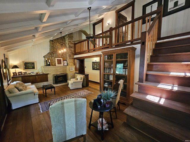 living room featuring ceiling fan, a stone fireplace, beamed ceiling, high vaulted ceiling, and hardwood / wood-style flooring