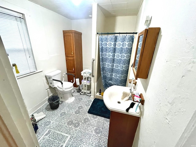 bathroom featuring tile patterned floors, vanity, a shower with shower curtain, and toilet