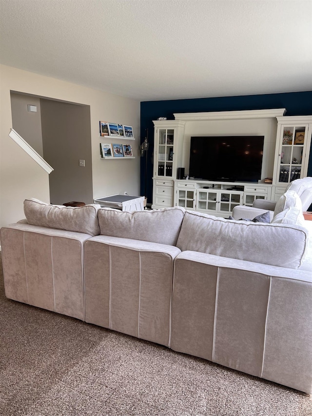 living room with carpet flooring and a textured ceiling