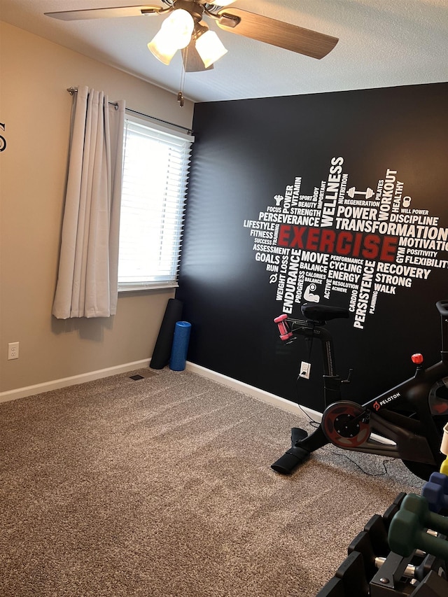 workout area featuring ceiling fan and carpet floors